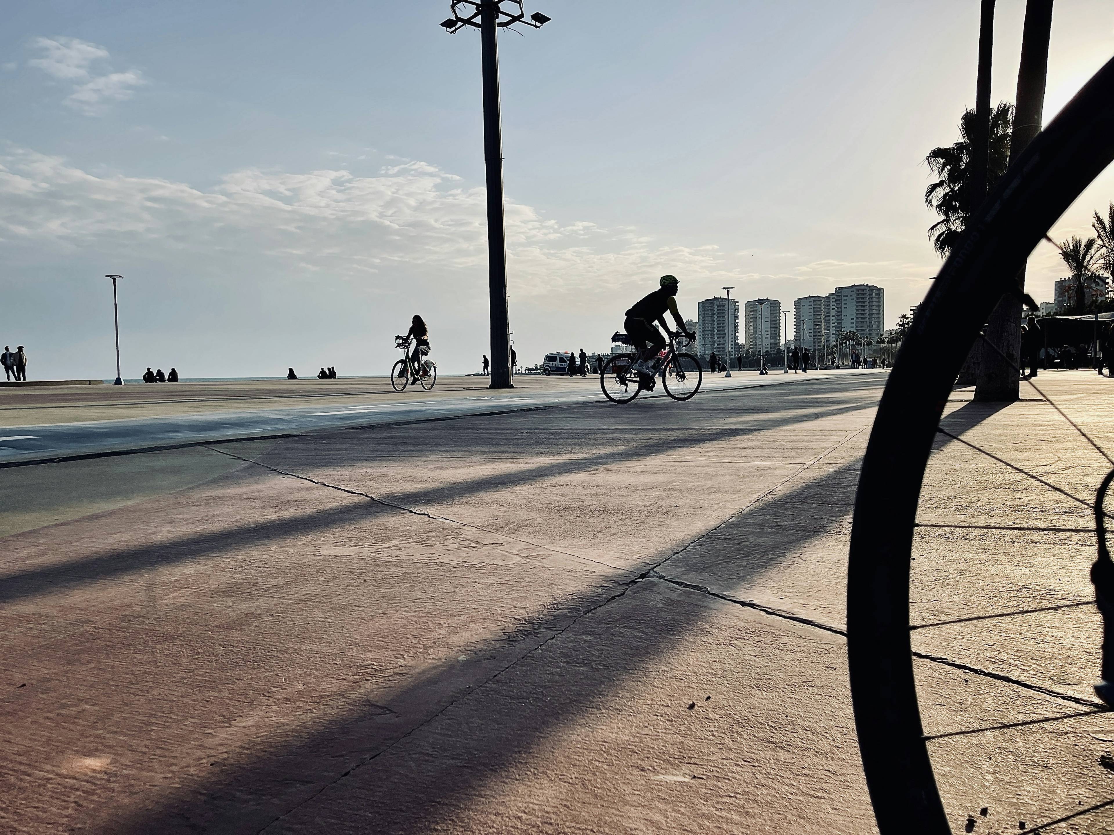 Cyclists enjoying the Balboa Peninsula bike path in Newport Beach on a sunny day