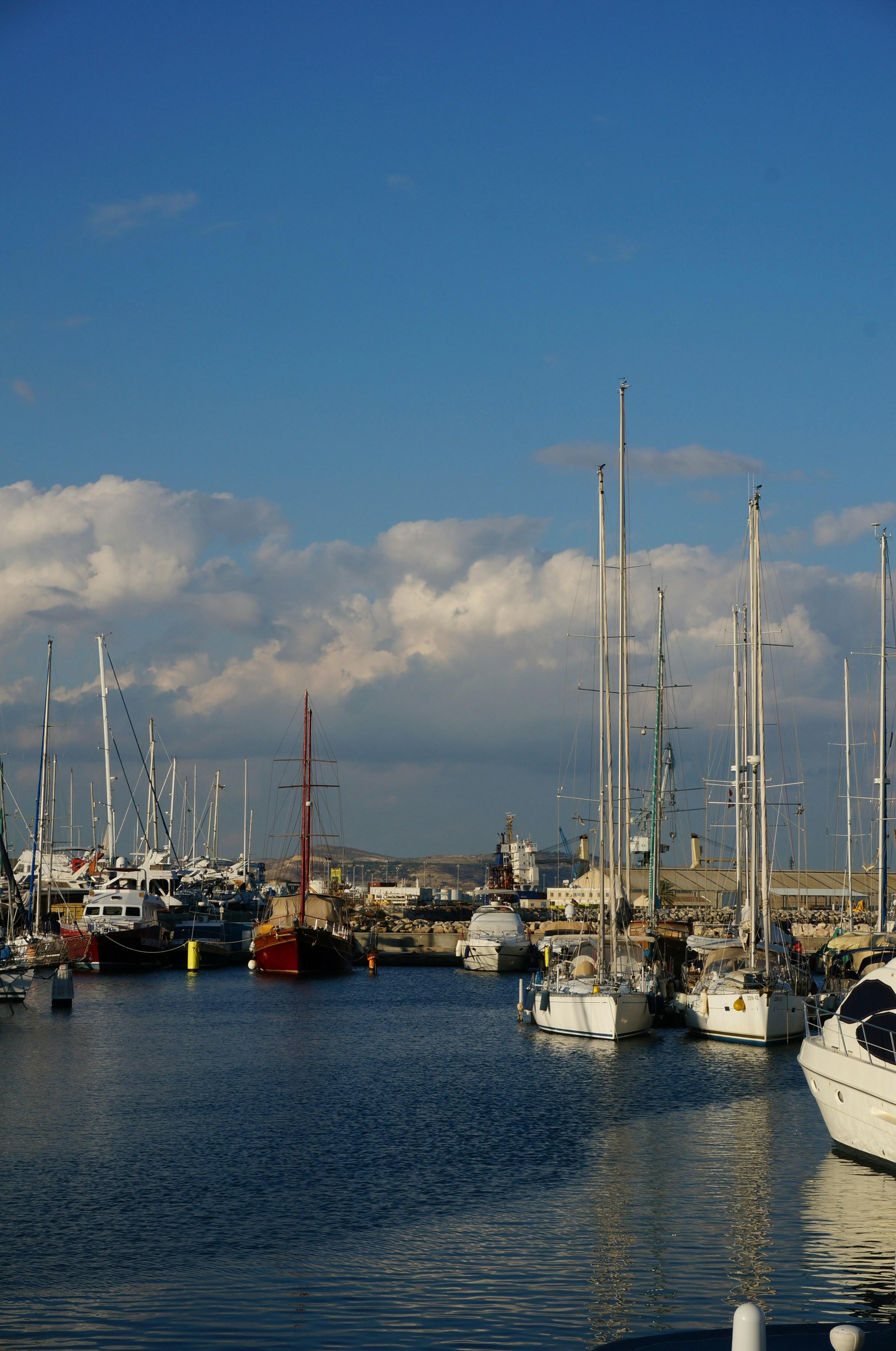Sailboats moored at Newport Harbor yacht club with blue sky