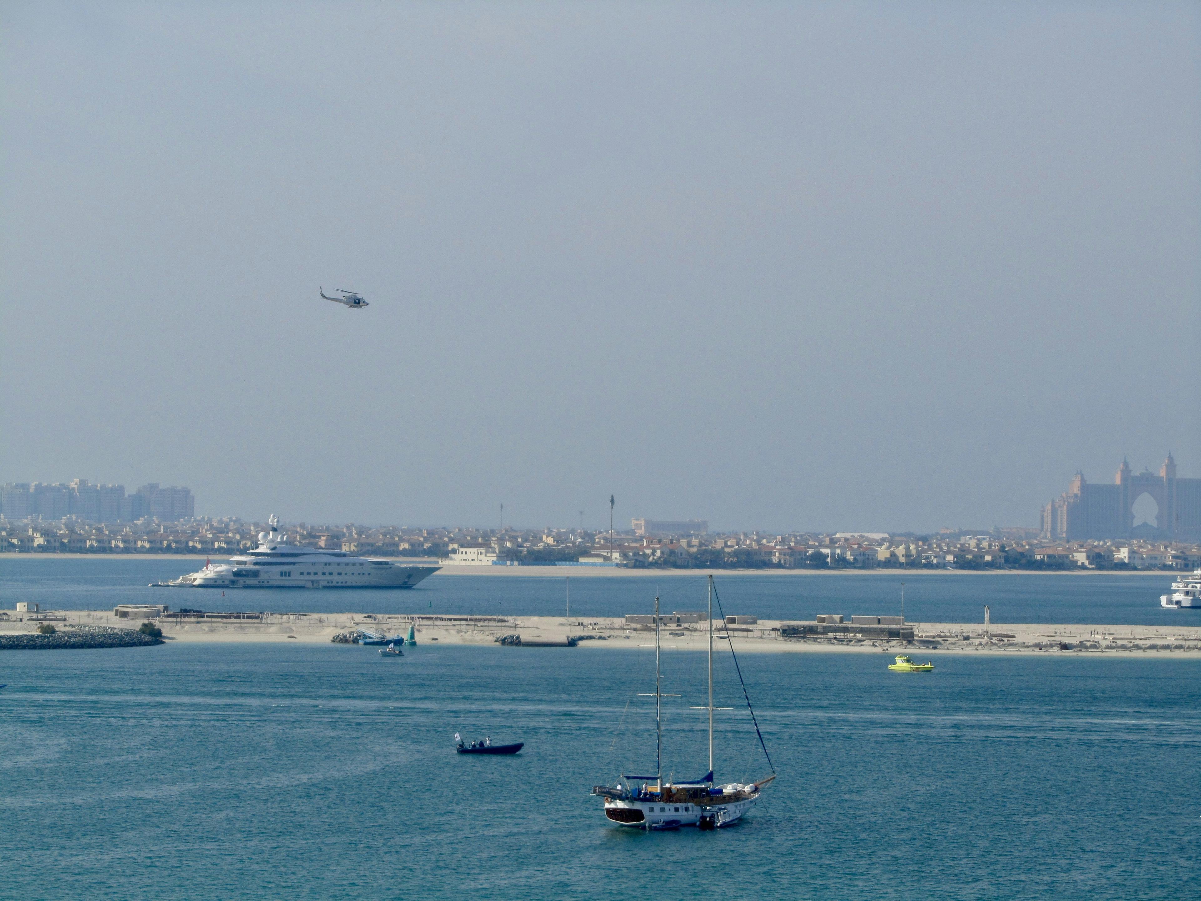 Helicopter flying over Newport Beach coastline with ocean and harbor views below