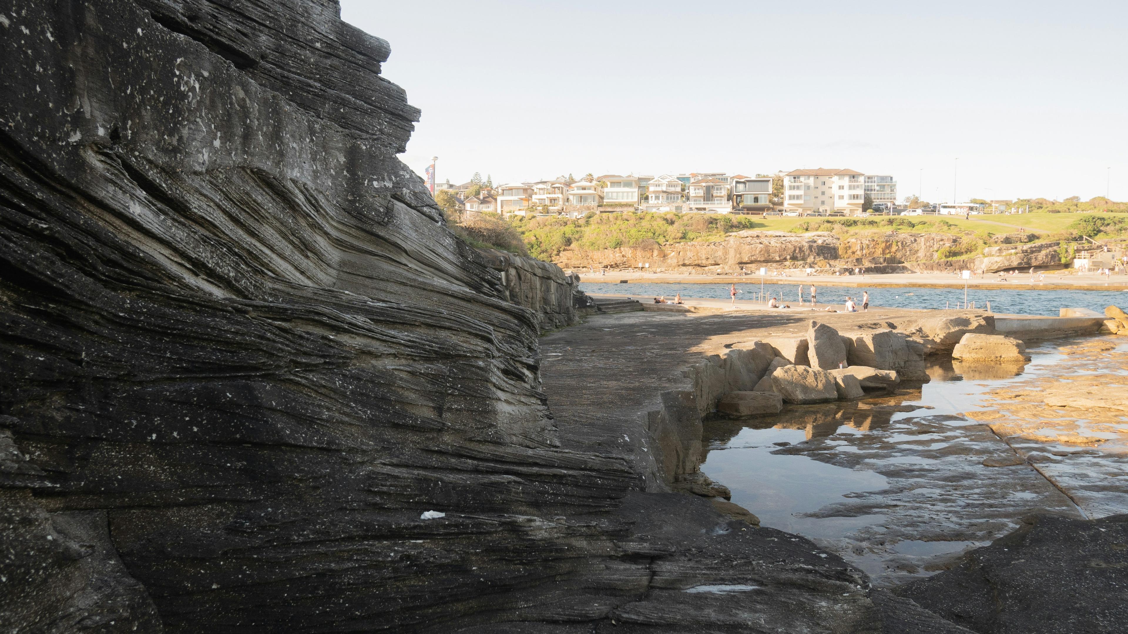 Newport Beach coastline with people enjoying the beach and ocean activities