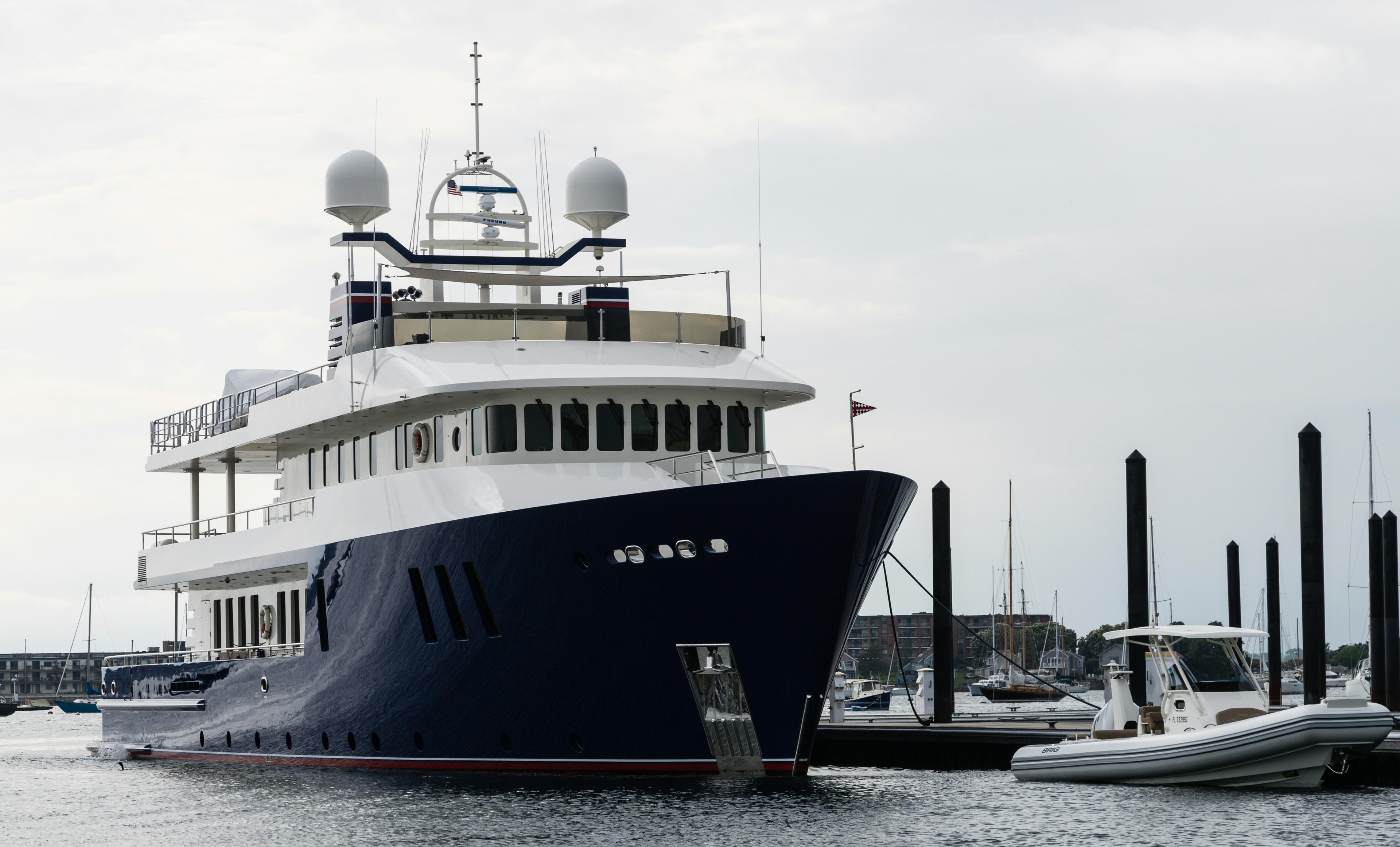 Private yacht captain at helm navigating Newport Harbor