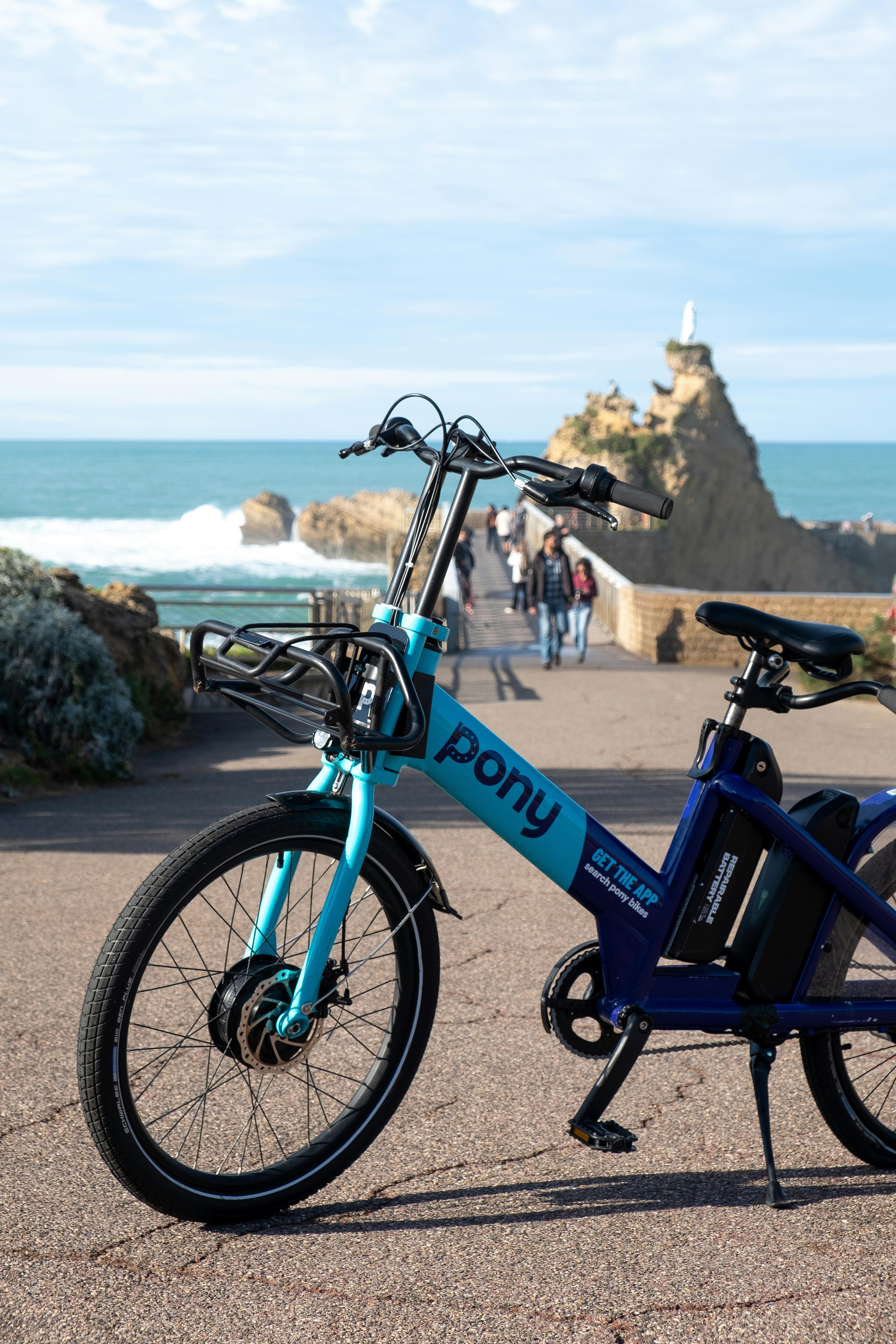 Family biking along the Balboa Peninsula bike path with ocean views