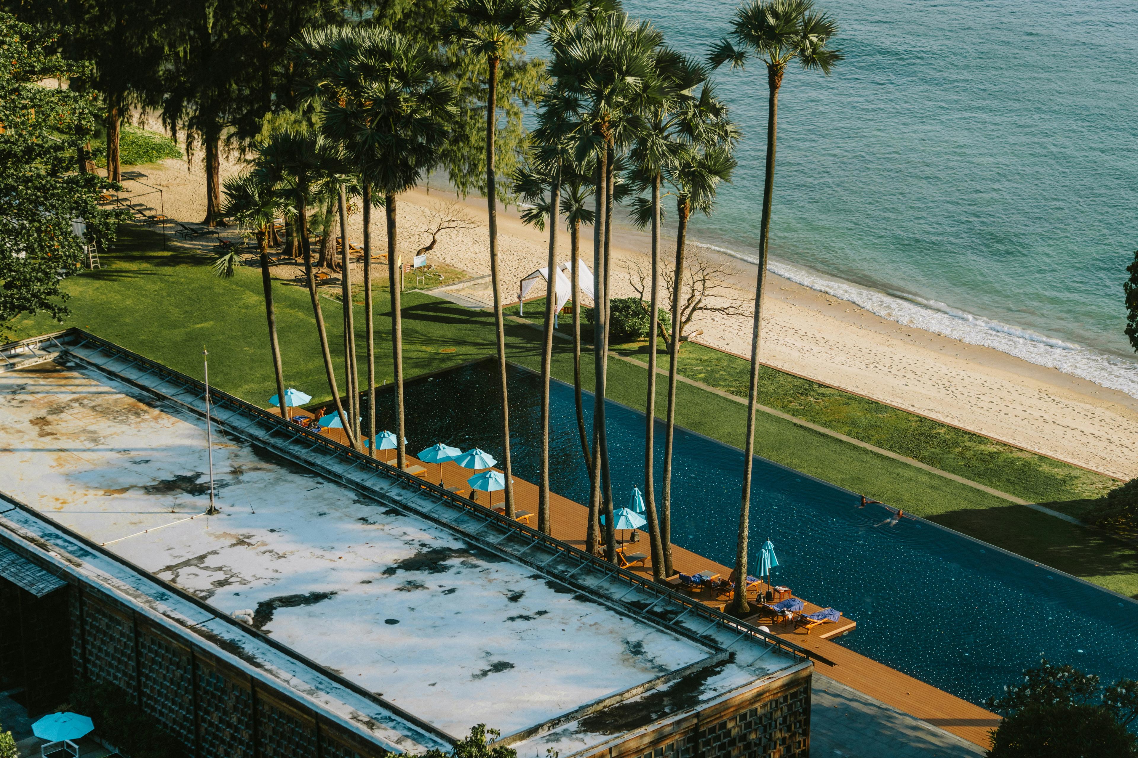 Newport Beach resort hotel pool area with palm trees and ocean views