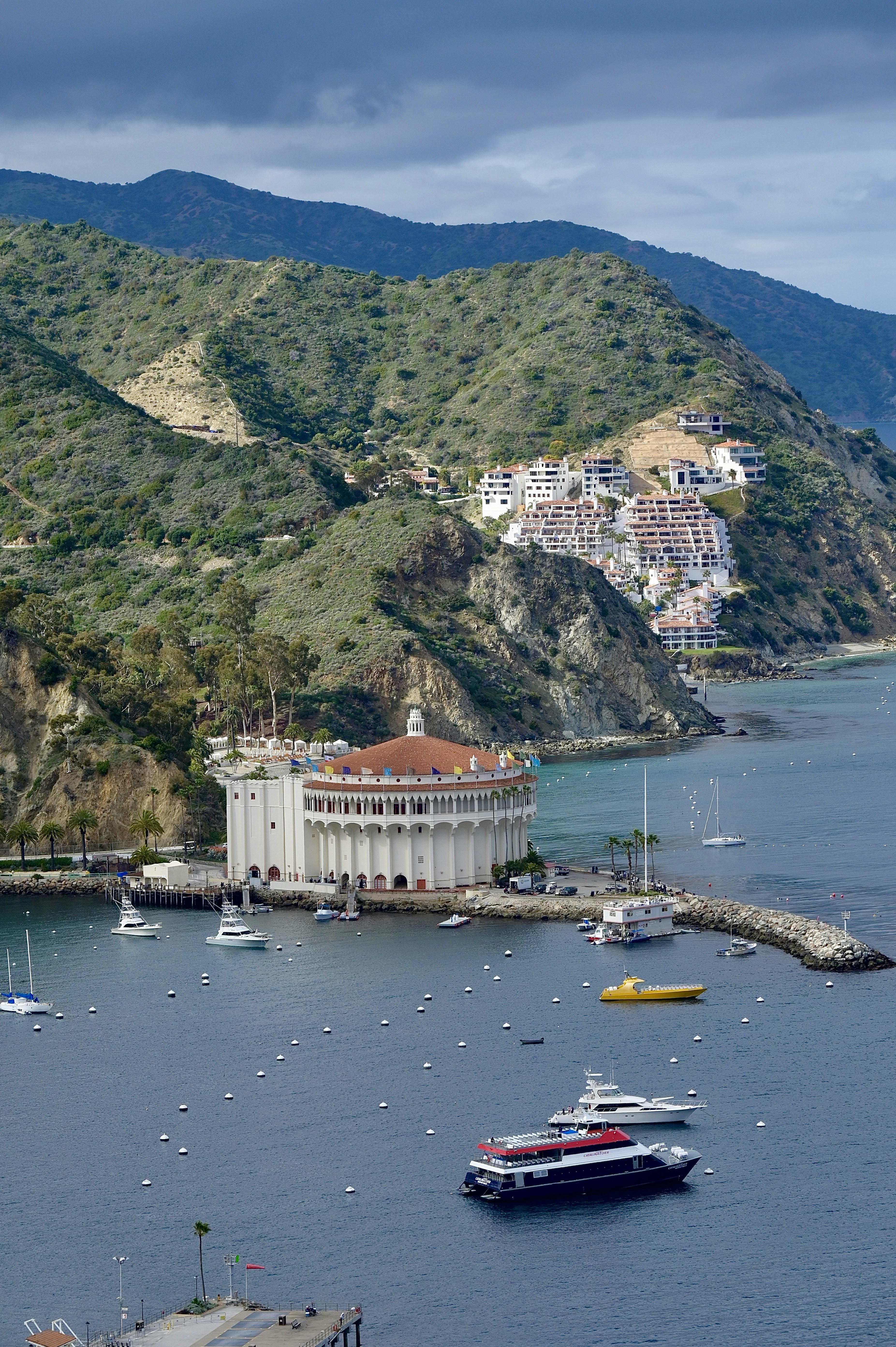 Catalina Island Avalon harbor at sunset with the iconic Casino building glowing in warm light
