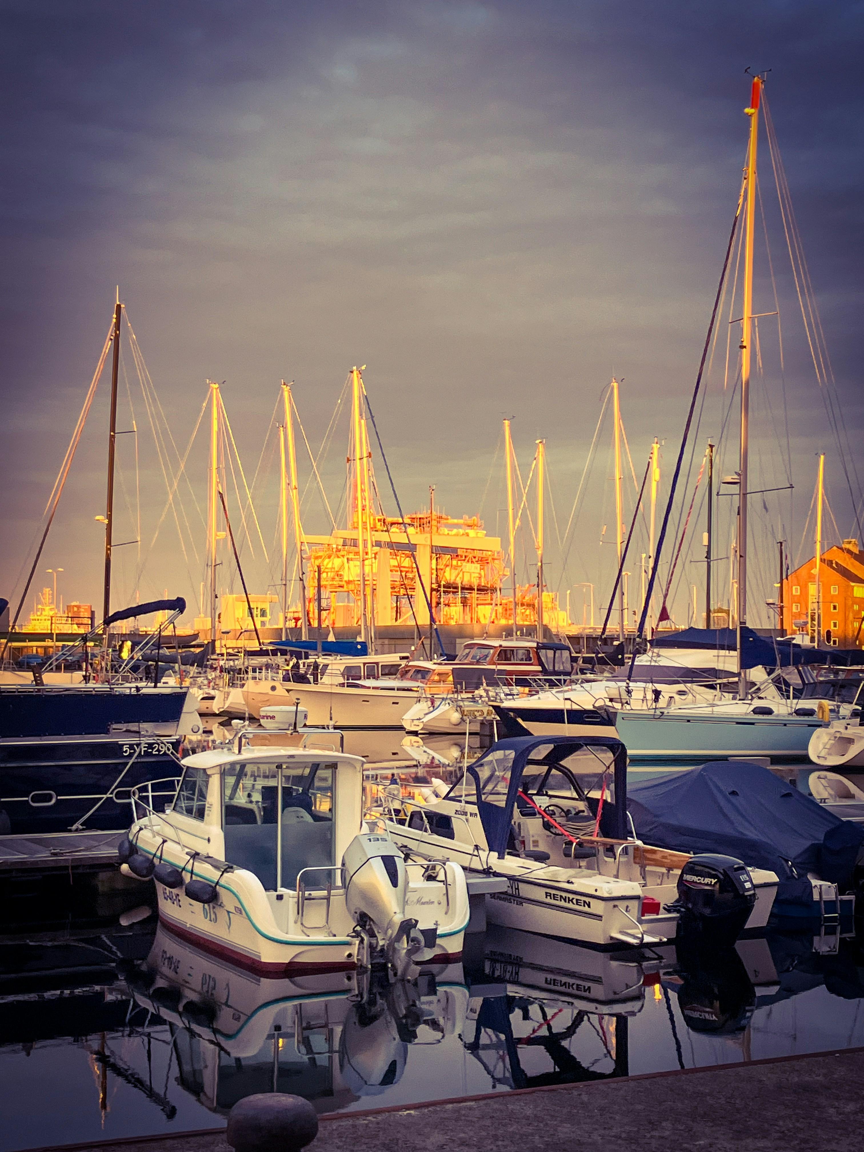 Newport Harbor waterfront with boats and restaurants at golden hour
