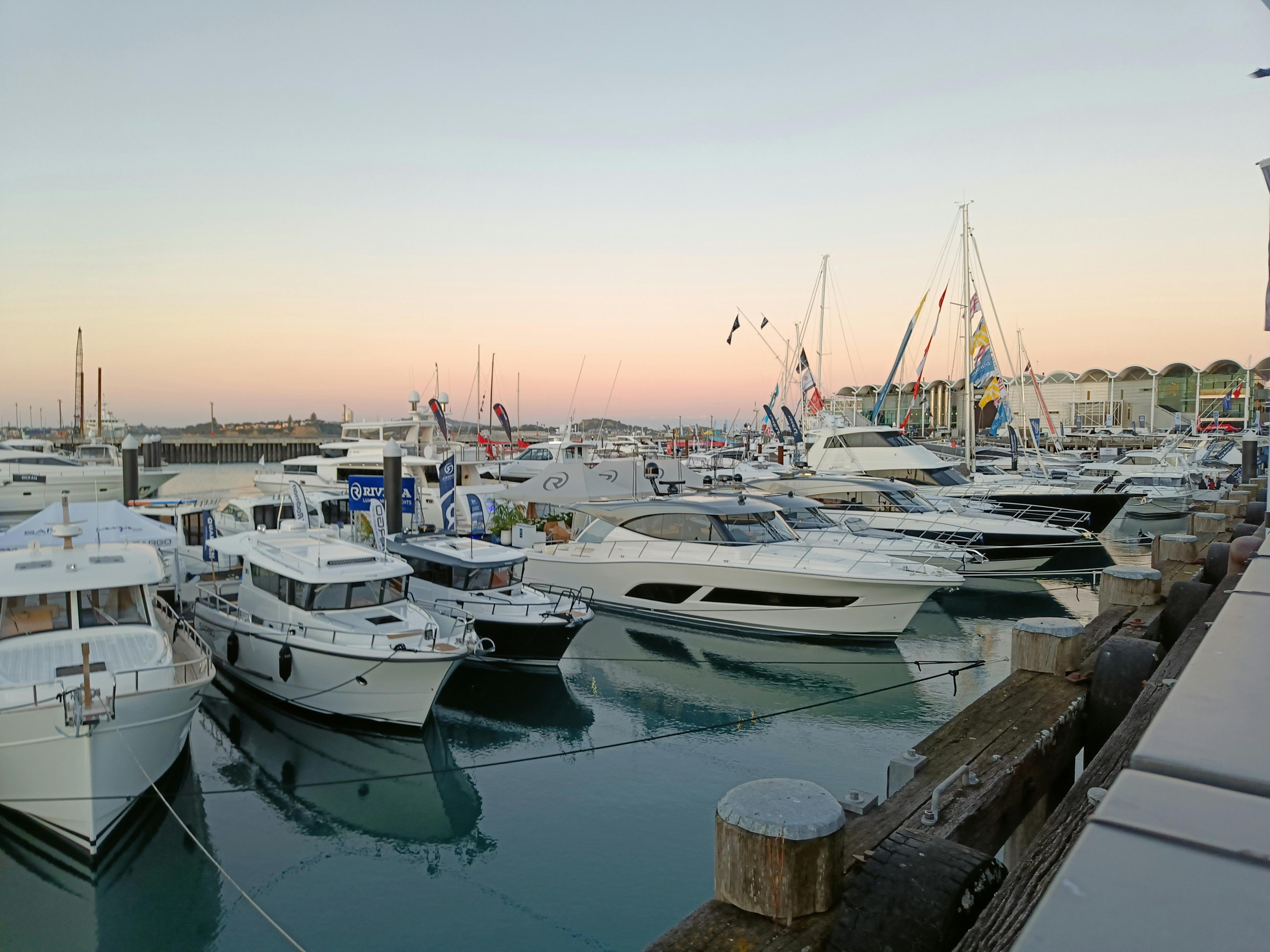 Luxury motor yacht moored in Newport Harbor at sunset