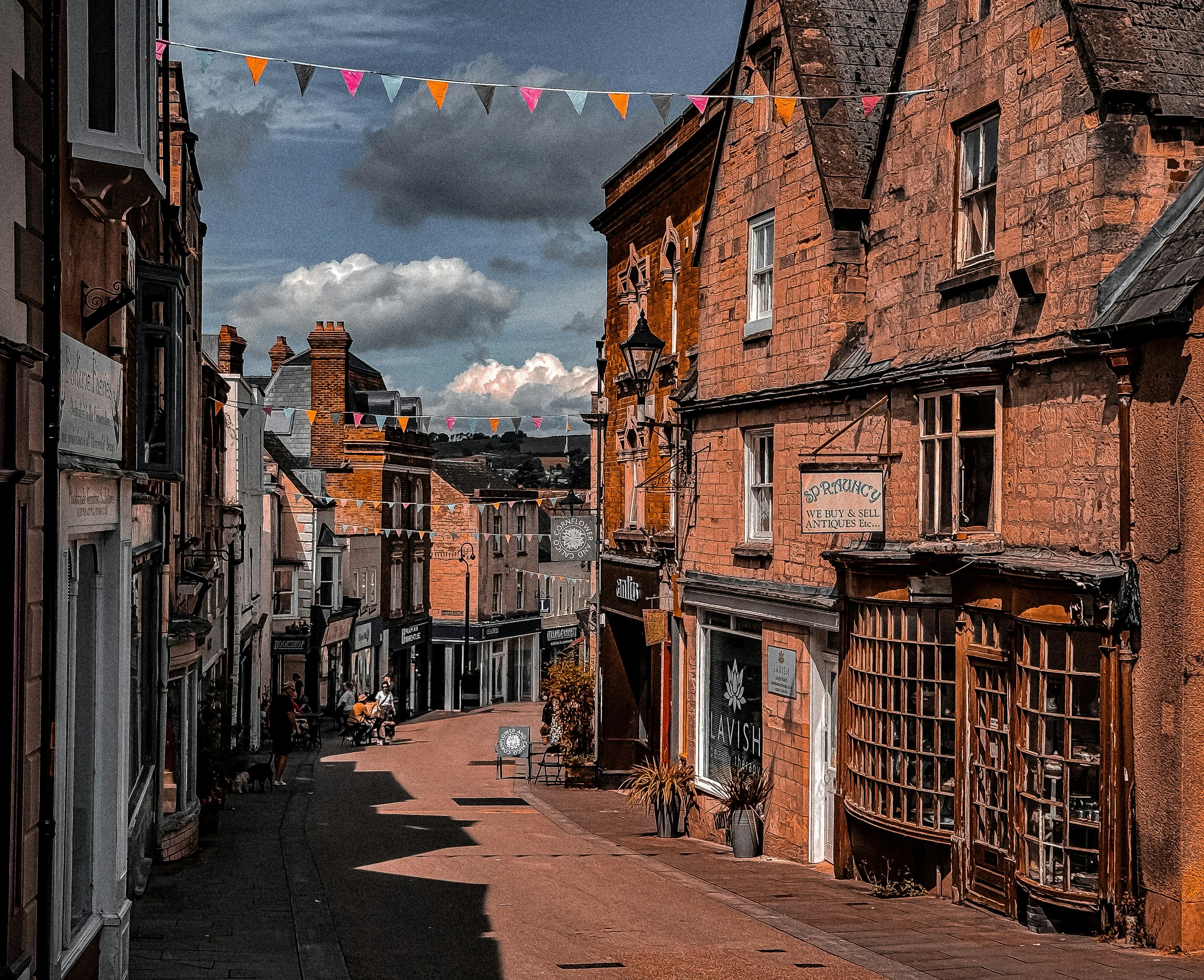 Charming boutique shopping street with colorful storefronts and outdoor displays