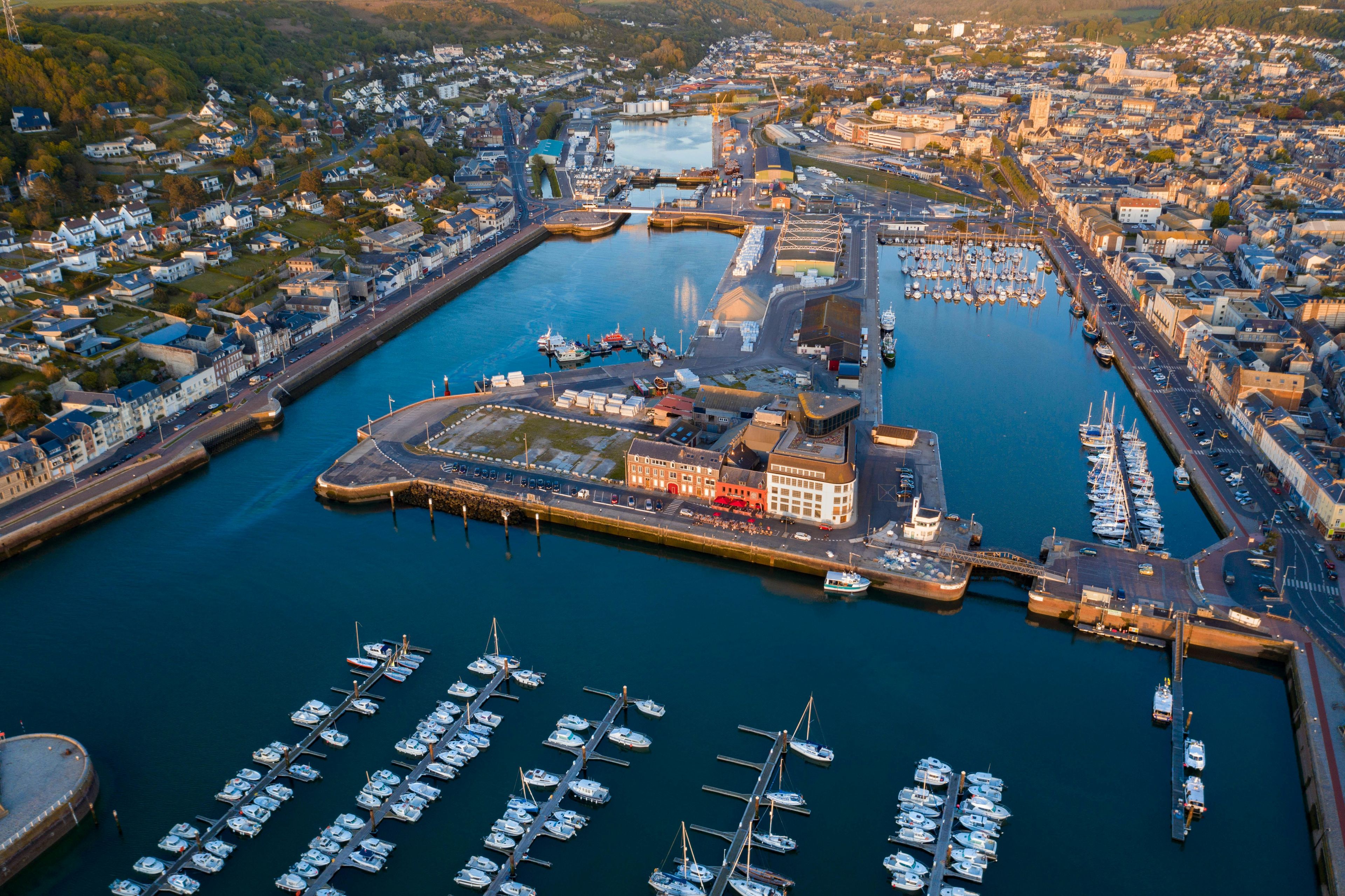 Aerial view of Newport Harbor with diverse neighborhoods and waterfront homes at golden hour